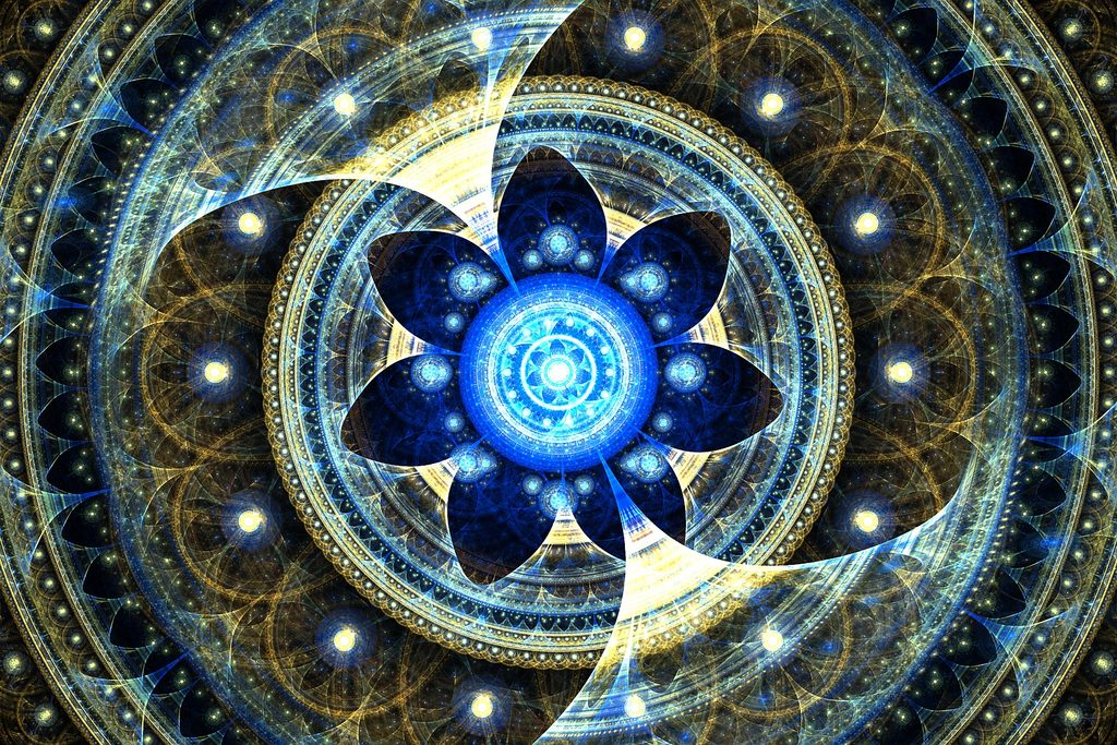 Intricate blue and gold fractal art featuring a luminous turquoise circular center, symmetrical petal-like shapes, and elaborate cosmic patterns.